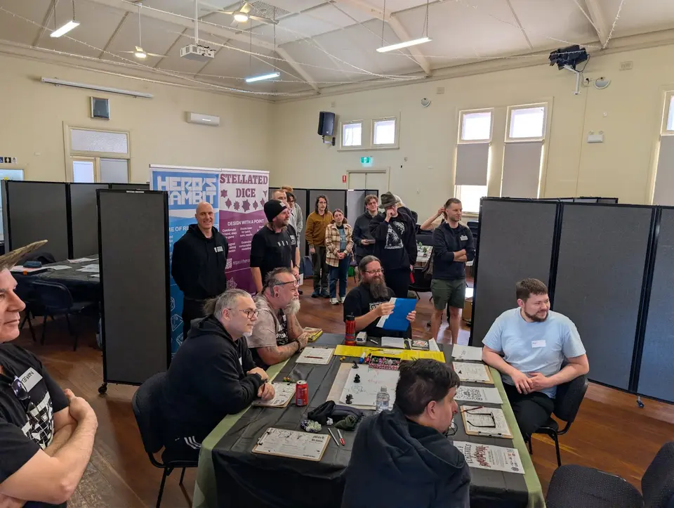 Wide view of the hall at OZ ORC, with players at tables between partition screens